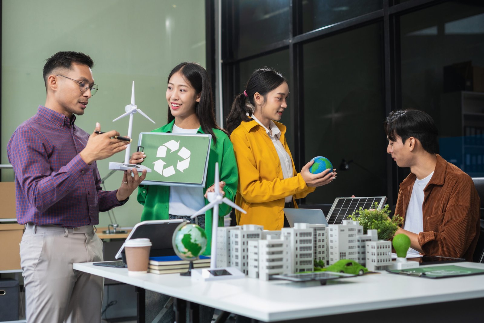Businessman team brainstorming using tablet, laptop computer for working technology and business, Renewable energy-based green businesses and global warming. Reduce CO2 emission.