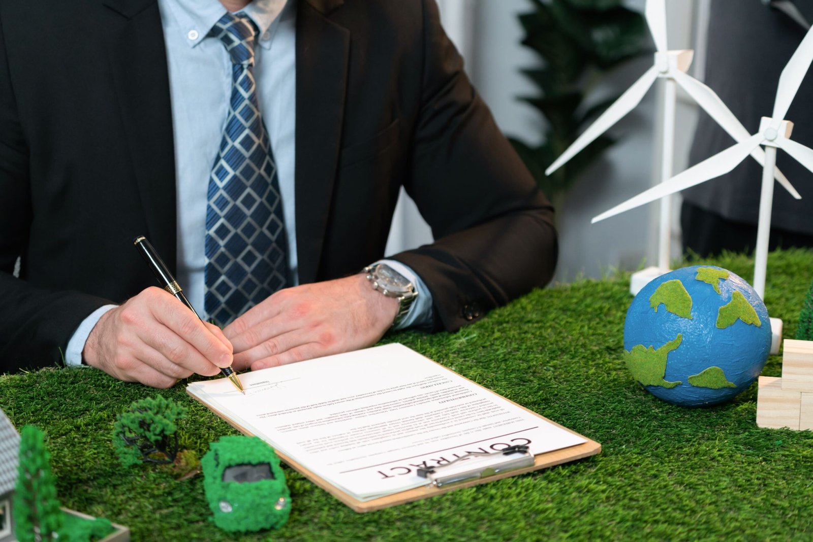 Businessman or CEO in office signing environmental regulation agreement to save Earth with sustainable energy utilization and CO2 reduction for greener future. Quaint