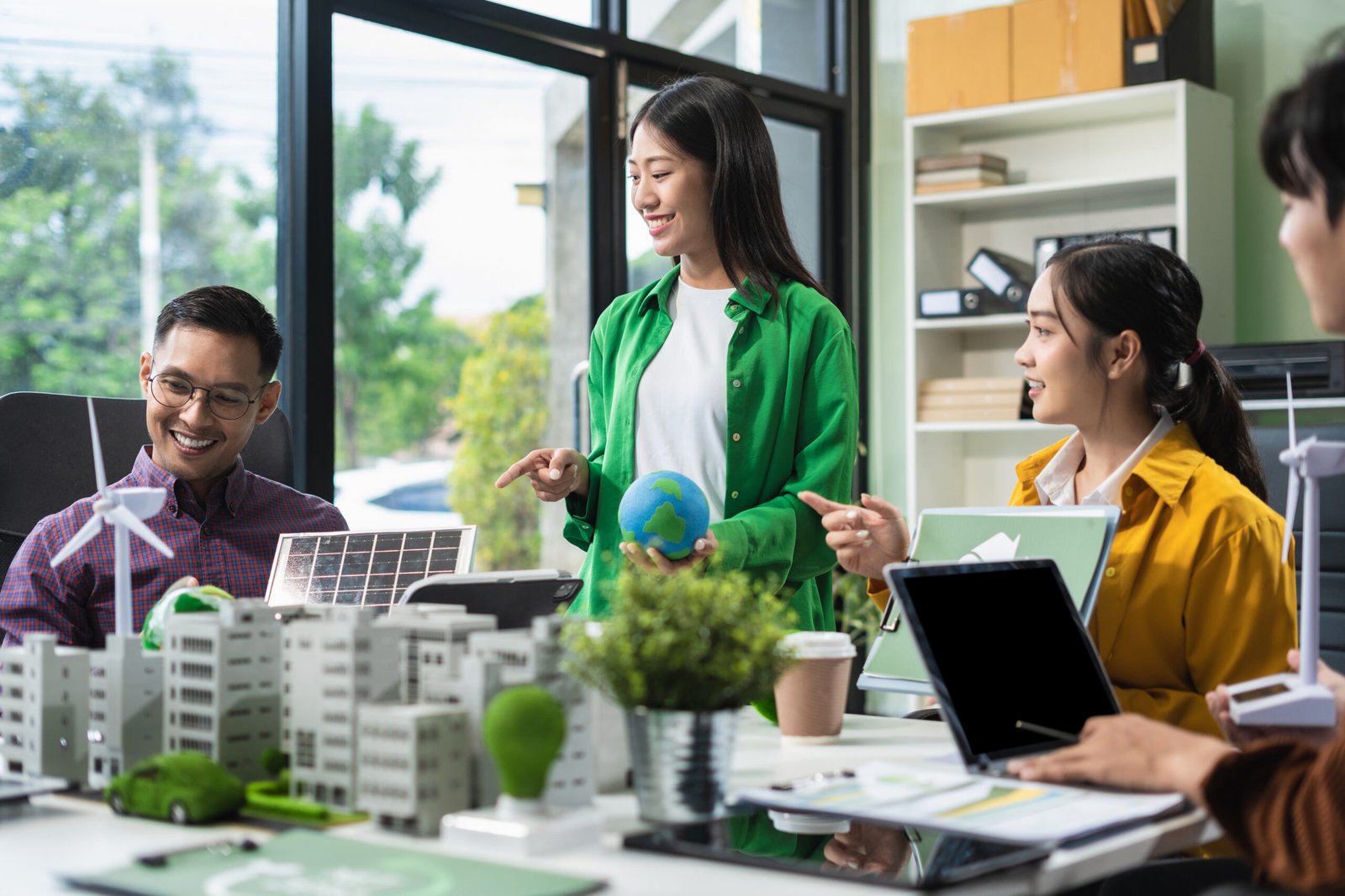 Businessman team brainstorming using tablet, laptop computer for working technology and business, Renewable energy-based green businesses and global warming. Reduce CO2 emission.