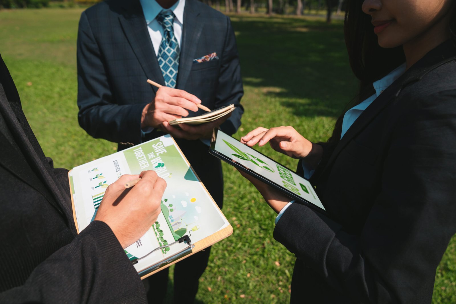 Group of asian business people presenting environmentally friendly development plan and sustainable technology project for greener future, establishing outdoor eco business office at natural park.Gyre