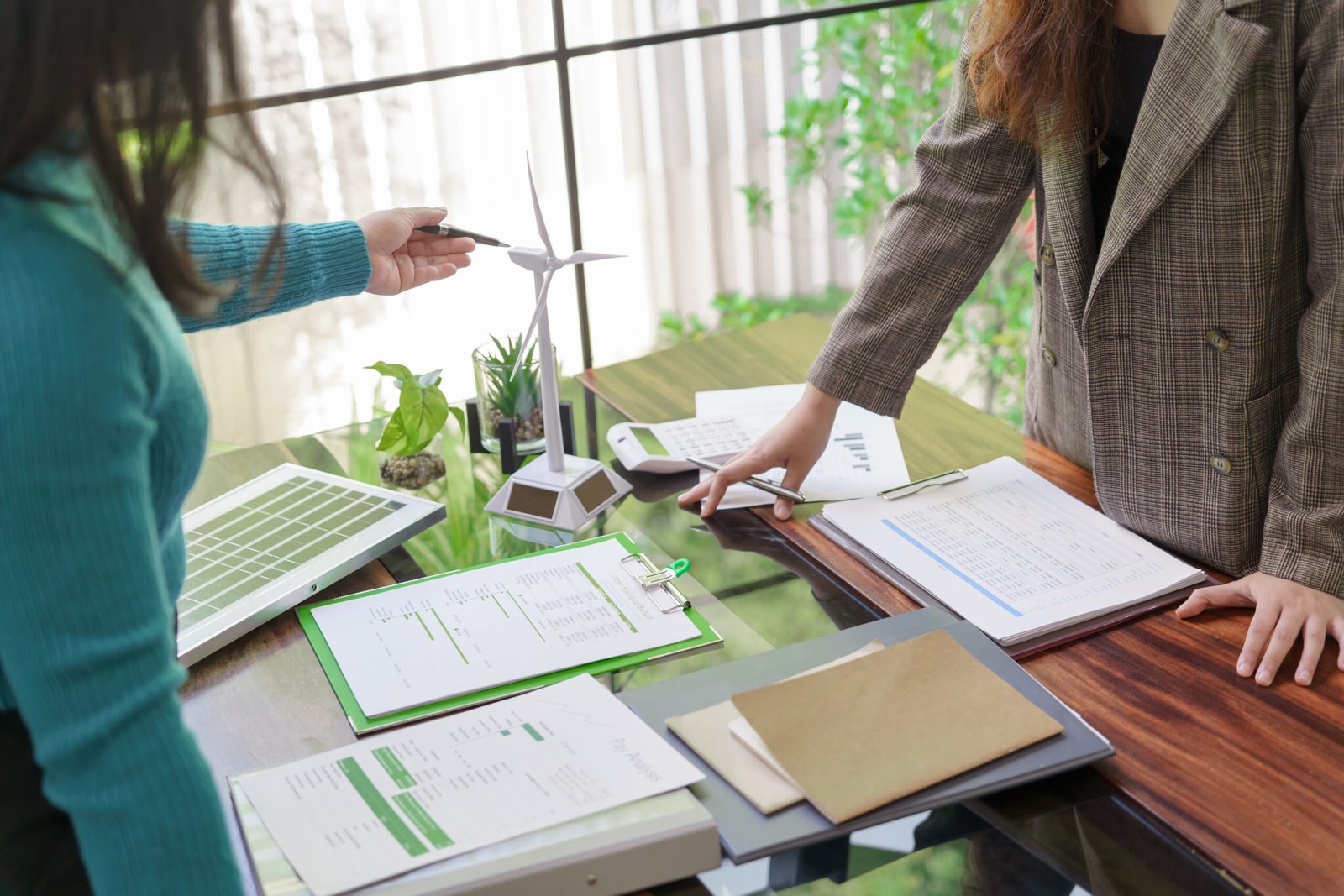 Solar panels green energy Business people working in green eco friendly office business meeting creative ideas for business eco friendly professional teaching corporate people sustainable electricity.