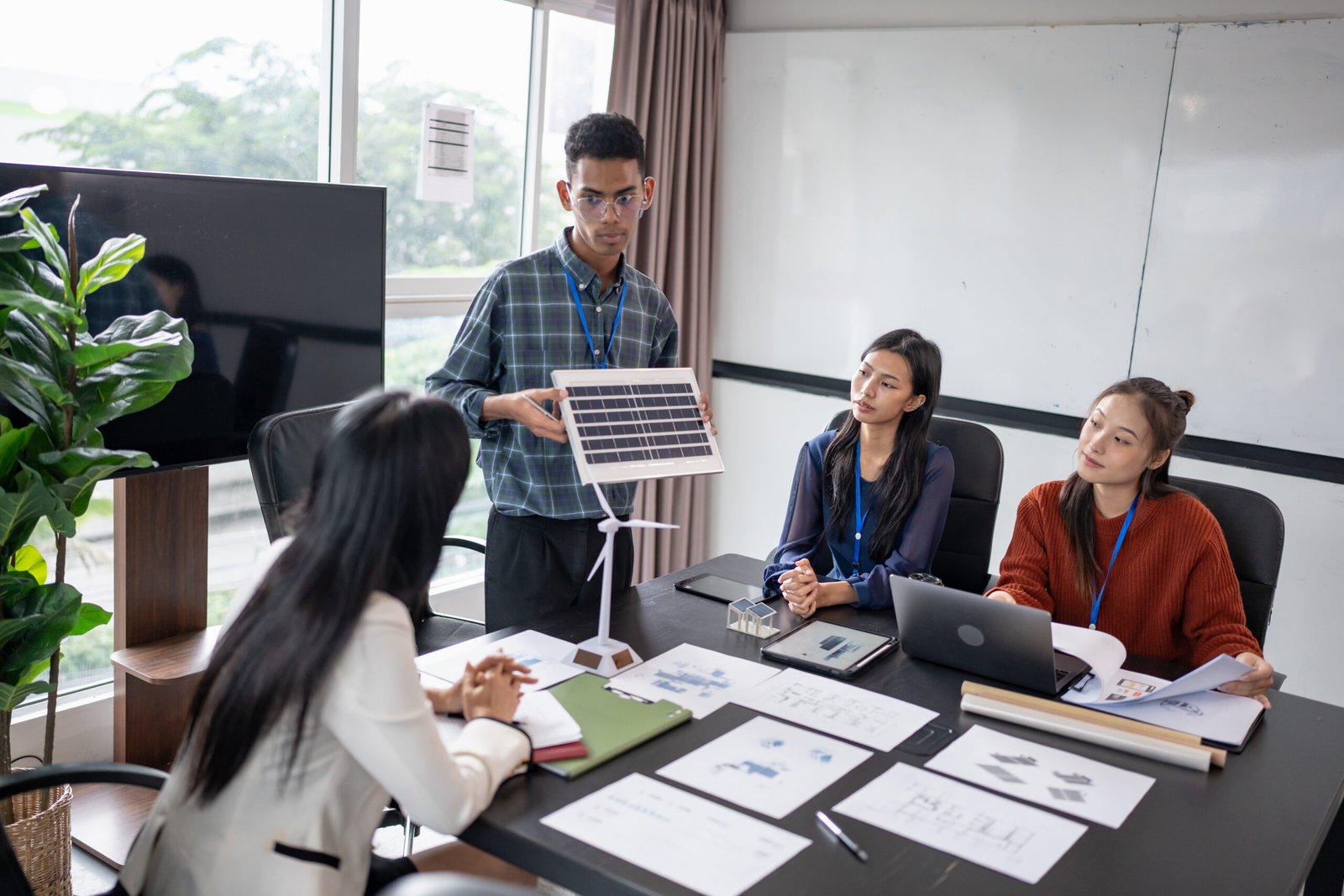 Solar panels green energy Business people working in green eco friendly office business meeting creative ideas for business eco friendly professional teaching corporate people sustainable electricity.