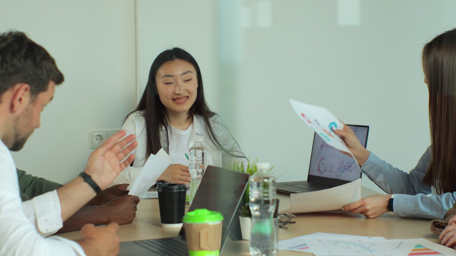 Business team sharing ideas about the financial development of their company. They are discussing over financial data and graphs