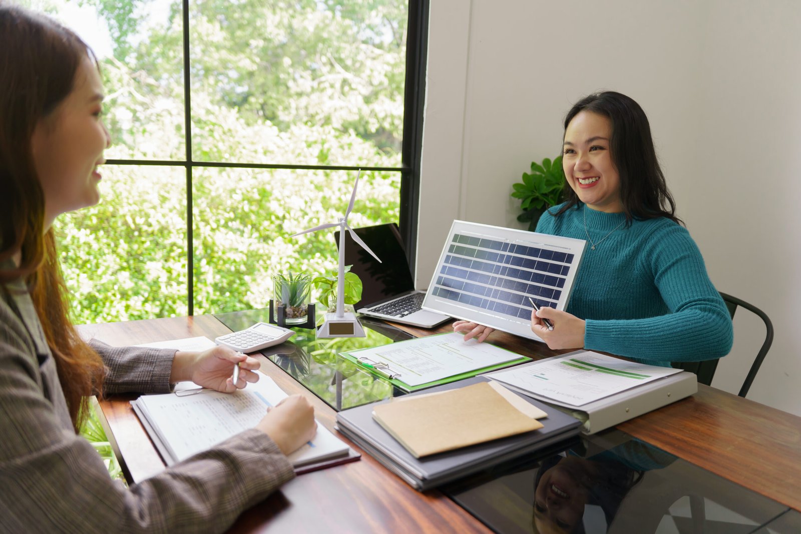 Solar panels green energy Business people working in green eco friendly office business meeting creative ideas for business eco friendly professional teaching corporate people sustainable electricity.