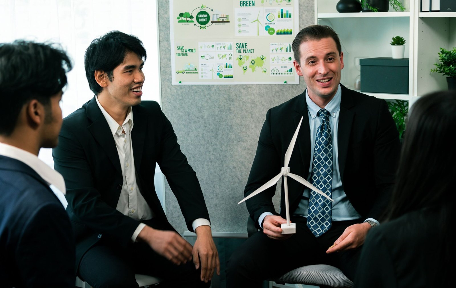 Diverse group of business people discussing for alternative energy utilization for greener sustainable Earth by reducing CO2 emission and carbon credit with renewable clean energy technology. Quaint