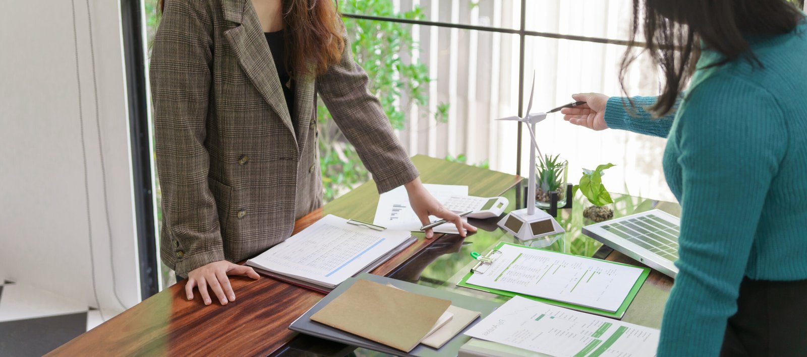 Solar panels green energy Business people working in green eco friendly office business meeting creative ideas for business eco friendly professional teaching corporate people sustainable electricity.